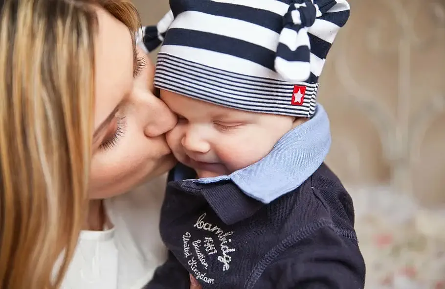 une maman fait un bisou a son enfant